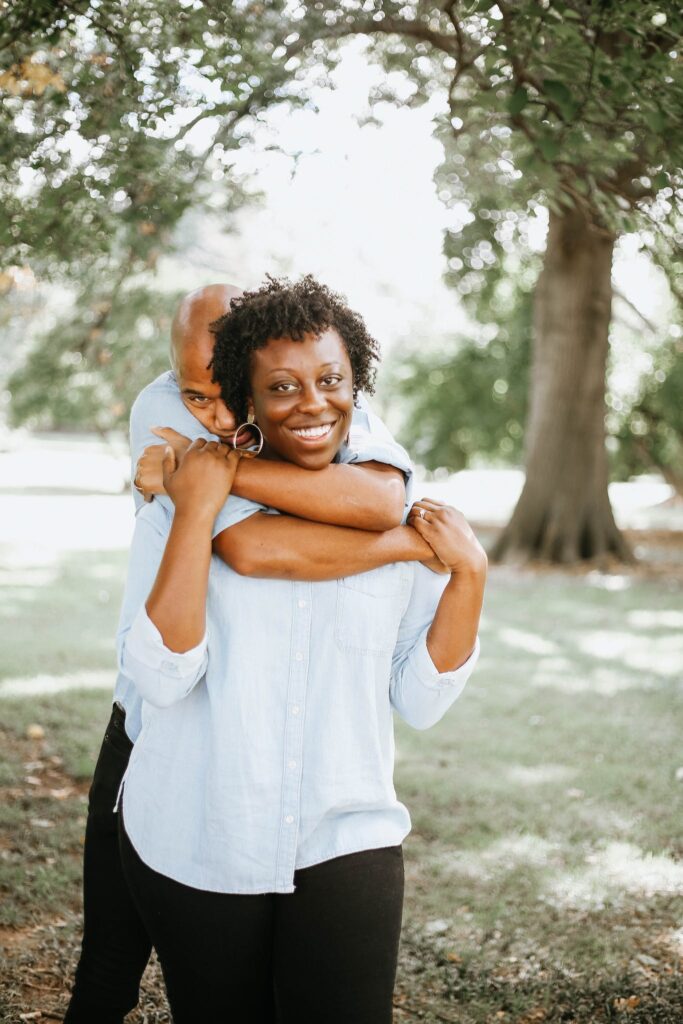 Man Hugging Woman on Her Back